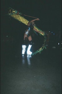 a dancer with a dragon on her feet at night